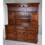 18th Century style dresser and rack, the fret carved top above shelves and cupboard doors, the