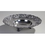 Mexican white metal dish, decorated with embossed grape and leaf decorated within scroll panels,