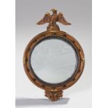 Gilt wood convex mirror, of small proportions, surmounted by an eagle above a convex mirror and ball