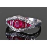 Ruby and diamond white metal ring, the elliptical head set with a row of rubies, surrounded by