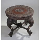 19th Century Indian centre table, the circular top with deeply carved elephant, figural and