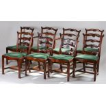 Set of eight George III style mahogany dining chairs, with arched and looped ladder backs, drop in