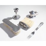 Mixed silver, to include two brushes, a silver candlestick, a silver mustard and a silver fork, (5)