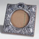 Silver frame, decorated with cherubs to the corners, leaf and flower design, 14.5cm wide