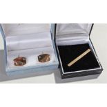 9 carat gold cuff links and tie clip, the cuff links with a swag engraved corner and diamond set