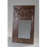 Arts & Crafts style copper framed mirror, possibly Scottish, decorated with bull rushes and water