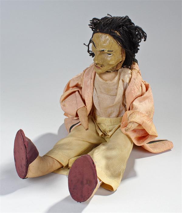 Unusual early 20th Century doll, of a man with long black hair, painted cloth face, 36cm high