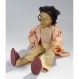 Unusual early 20th Century doll, of a man with long black hair, painted cloth face, 36cm high