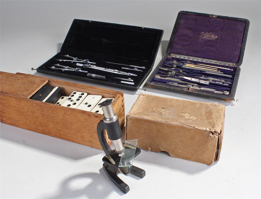 Two drawing sets, together with a microscope and a domino's set, (4)