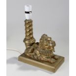 Early 20th gilt bronze table lamp, in the form of a lion, laying on a plinth base, 22cm long, 11.5cm