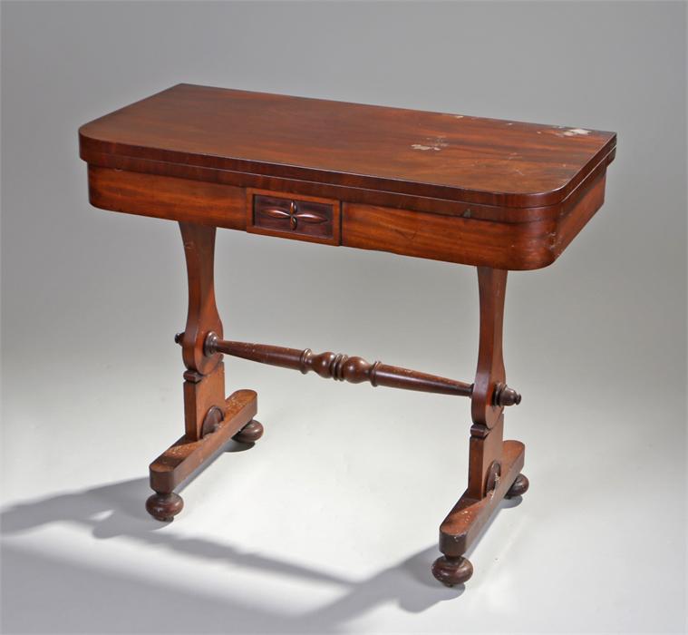 Victorian mahogany games table, the rectangular top with rounded corners above shaped supports and