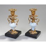 Pair of 19th Century ormolu mounted candlesticks, the candlesticks with gilt metal mounts, porcelain