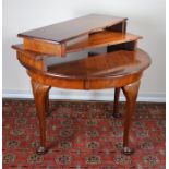 Walnut extending dining table, the circular top above cabriole legs and pad feet, to include two