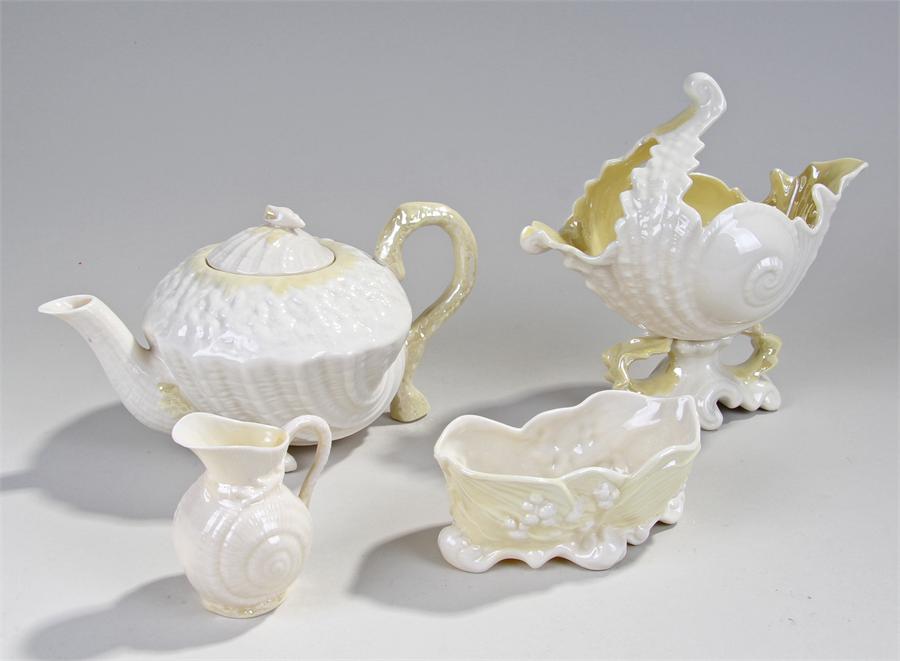 Four pieces of Belleek, to include a conch shell,