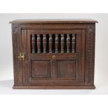 Mid 17th Century and later oak food hutch, the rectangular top above turned half spindle door and