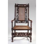 Charles II walnut elbow chair, the cherub carved foliate rail above a caned back and rose carved