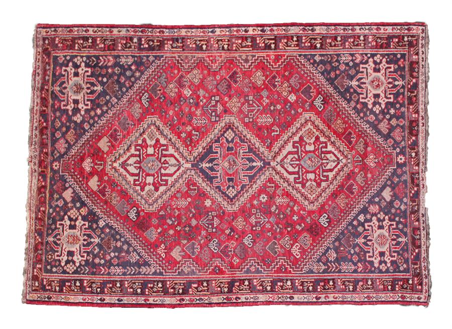 West Persian rug, with a red field, three medallions and club pattern, double borders, 241cm x