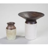 Two pieces of contemporary pottery, the wide lip in charcoal brown above a white base, 13cm high,