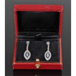 White and yellow metal diamond and sapphire earrings, the navette shaped drops with an estimated