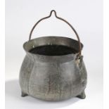 17th Century bronze cauldron of large proportions, the arched lip above a bulbous body, loop