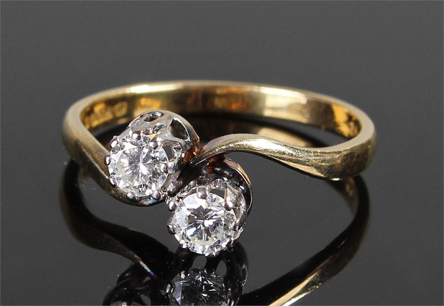 18 carat gold diamond ring with two diamonds in a cross over shank, diamonds approximately 0.30