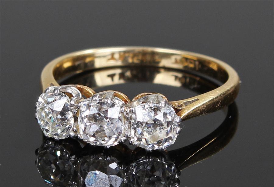 18 carat gold diamond set ring, with a row of three diamonds, the central at approximately 0.70