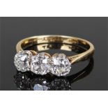 18 carat gold diamond set ring, with a row of three diamonds, the central at approximately 0.70