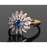 18 carat gold diamond and sapphire ring, the central sapphire with diamond set leaf surround, ring