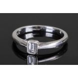 Platinum and diamond set ring, emerald cut diamond at approximately 0.3 carats, raised shoulders,