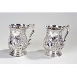 Near pair of Victorian silver plated tankards, the pair with foliate embossed decoration and