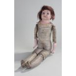 Early 20th Century bisque doll, the bisque head with blue eyes, bisque arms attached to a leather