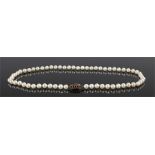 Pearl necklace with a row of between 6mm and 7mm diameter cultured pearls. With a 9 carat gold