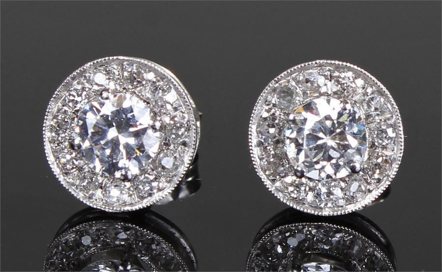 Pair of diamond ear studs, the central diamonds surround by a boarder of diamonds, approximate total