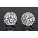 Pair of diamond ear studs, the central diamonds surround by a boarder of diamonds, approximate total