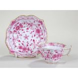 Meissen cup and saucer decorated with pink and reds with sprigs of flowers and a gilt dot and line