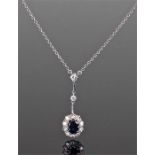 White gold sapphire and diamond necklace, the central sapphire surrounded by diamonds, two further