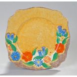 Clarice Cliff Bizarre plate, the yellow ground with blue, green and orange flower half border,