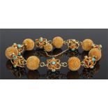 Yellow metal and turquoise set bracelet, with spiked ball and interlaced turquoise set links, 23.3