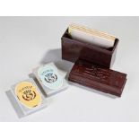 Early 20th Century Bakelite bridge box, the rectangular brown case with card suits to the top,