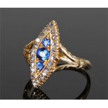 18 carat gold sapphire and diamond ring of navette form, three sapphires to the centre surrounded by