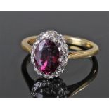 18 carat gold diamond and garnet set ring, the central garnet flanked by diamonds, ring size O