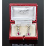 18 carat white gold diamond and ruby set earrings, both with a drop ruby at approximately 0.78 carat