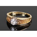 18 carat gold diamond set ring, the central diamond with back effect channelled shoulders, ring size