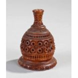 Early 19th Century powder coquilla nut. The pierced top with high neck above a carved body, 7cm