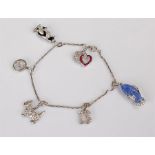 Cartier 18 carat white gold diamond, ruby and sapphire set charm bracelet, the charms to include a