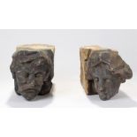 Two 19th Century stone corbels, depicting male and female heads, 39cm long (2)