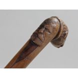 Late 19th Century Greek wooden walking stick, the handle carved with a beasts head, mask of a