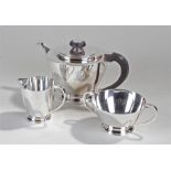 George VI three piece silver tea set Birmingham, 1939, Adie Brothers Ltd. The teapot with a wooden