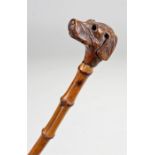 Victorian carved dog head walking stick. The dog head deeply carved with long ears, raised on a cane