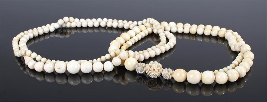 Two sets of early 20th Century Chinese ivory and bone beads. The first with carved foliate beads